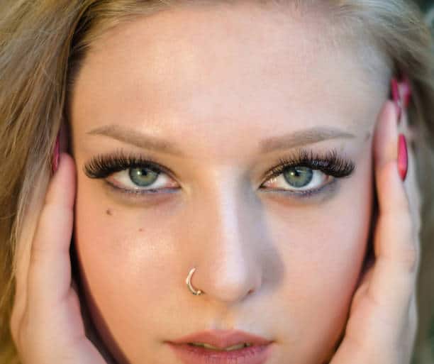 Portrait of a young beautiful girl close-up. Model with pierced nose